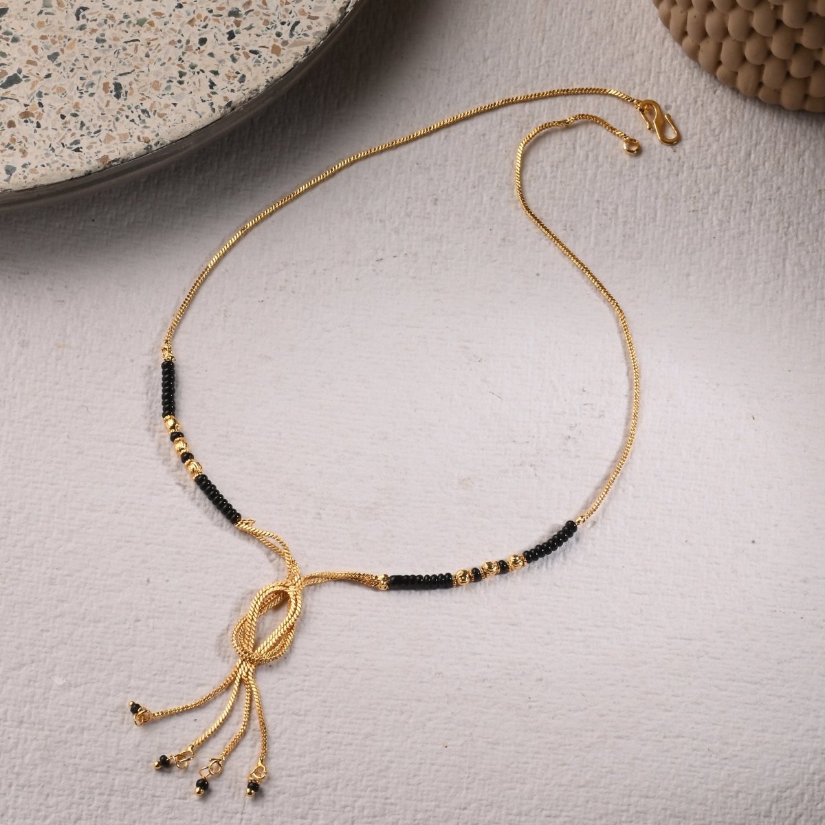 AanyaCentric Gold-Polished Jewelry Combo: Elegant Short Mangalsutra, Finger Ring, and American Diamond Earrings Set
