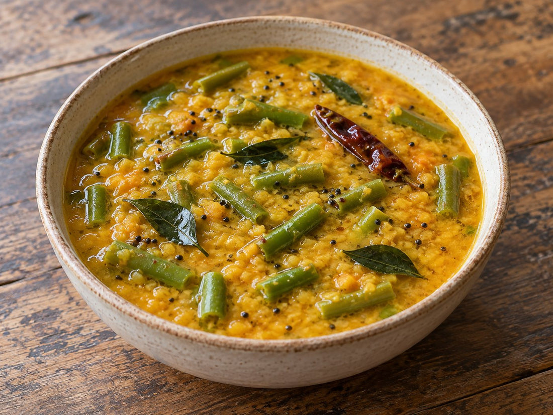 Illustrative red-lentil sambar with green beans and mustard seeds.