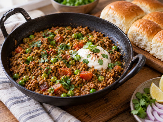 Lamb keema with peas and yoghurt in an iron kadai with pav