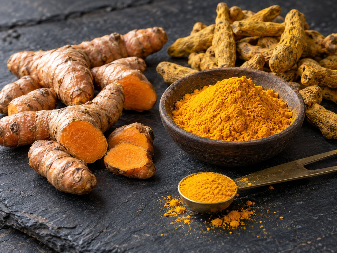 Fresh turmeric root, dried turmeric and a bowl of ground turmeric with a measuring spoon