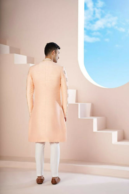 The Peach Sherwani Features Hexagonal Butas , V-Shaped Floral Jal Borders by Hilo Design