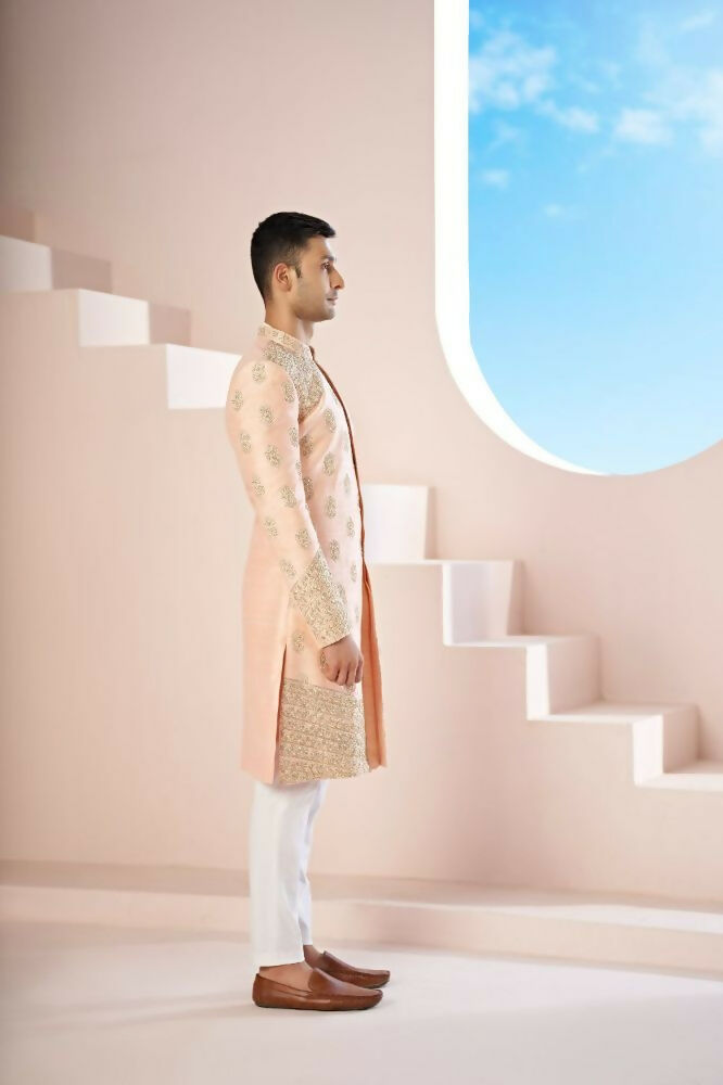 The Peach Sherwani Features Hexagonal Butas , V-Shaped Floral Jal Borders by Hilo Design