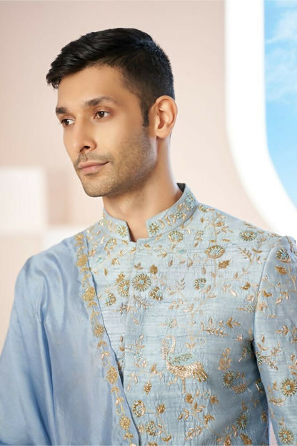 Majestic Blue Sherwani With Intricate Gold Crane And Floral Hand Embroidery. by Hilo Design